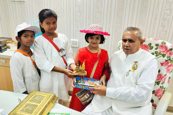 Children from Divine Sanskarshala presenting gifts to BK Mruthyunjaya, Additional Secretary General of Brahma Kumaris, during a meeting at the Brahma Kumaris headquarters.