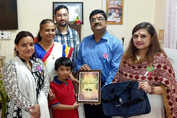 Ashok Banerjee, Joint Commissioner GST Varanasi, posing with staff members, a student, and representatives of Divine Sanskarshala during a special visit and felicitation ceremony.