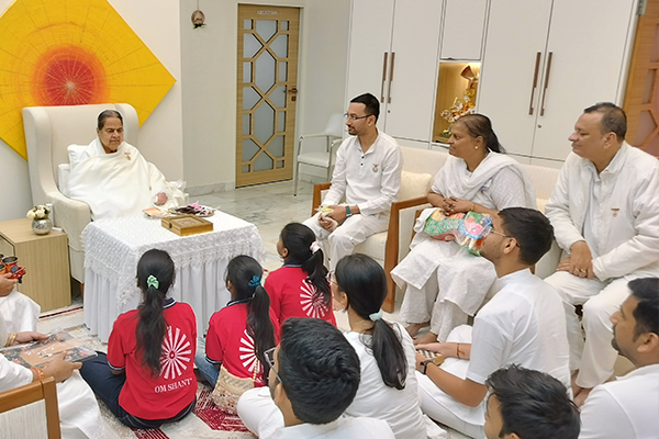 Students and members of Divine Sanskarshala seated with BK Mohini Didi during a spiritual meeting at the Brahma Kumaris headquarters.