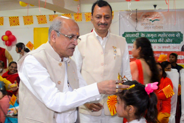 Keshav Jalan, Managing Director of the Jalan Group, interacting with and blessing a child during a cultural event at Divine Sanskarshala.
