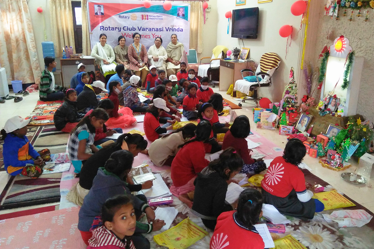 Children participating in a learning session at Divine Sanskarshala with members of Rotary Club Varanasi Vrinda, promoting education, creativity, and community support.