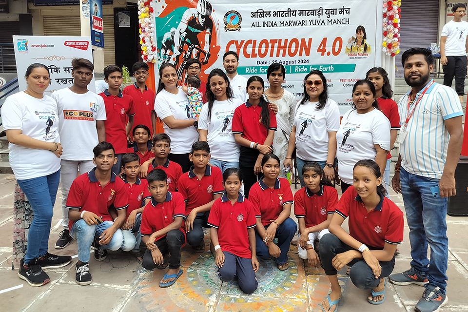 Group photo of Divine Sanskarshala children, volunteers, and supporters at Cyclothon 4.0, standing in front of the event banner promoting cycling, fitness, and environmental awareness.